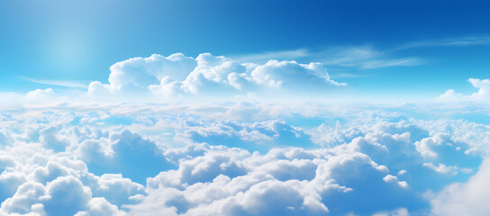 Above clouds from airplane window. Beautiful sky with white clouds and blue sky