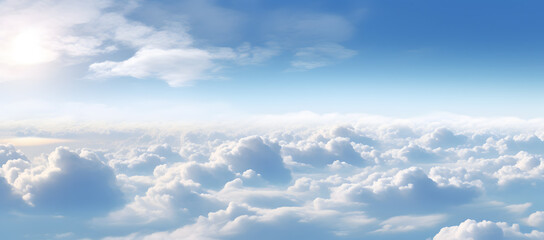 Fototapeta premium Above clouds from airplane window. Beautiful sky with white clouds and blue sky