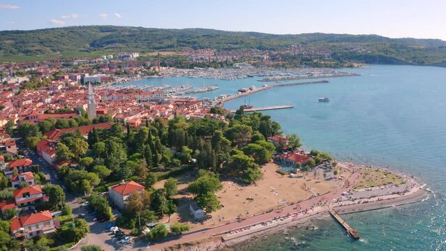4k drone forward video (Ultra High Definition) of Izola town, Slovenia, Europe. Sunny summer seascape of Adriatic sea. View from flying drone of old European sea port. Traveling concept background..