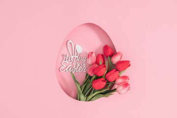 Easter holiday composition. Beautiful tulips flowers isolated on pastel pink background. Easter concept. Flat lay, top view, copy space