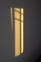 Sunbeam light reflecting the window shape on the wall. Interior design photography.