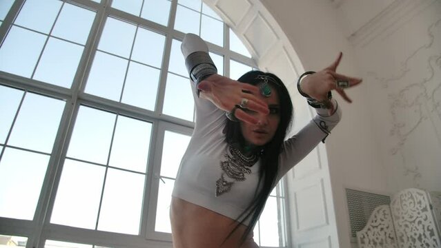 Dancing Girl in Beautiful Eastern Ethnic Dress. Sensuality in Belly Dance with Artistic Expressive Move One Woman. Festive Activity Expressions in Asian Tradition. Bright Oriental Costume on Performer