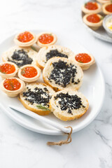 Assorted caviar served with bread and in tartlets