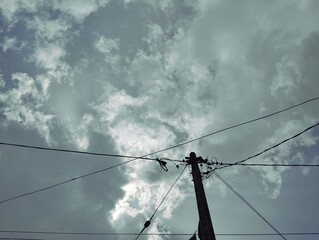 Silhouette of electric pole under the sky