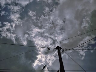 Silhouette of electric pole under the sky