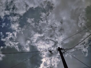 Silhouette of electric pole under the sky