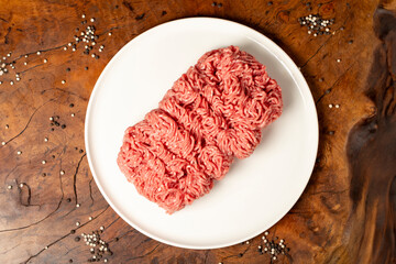 Ground beef. Butcher products. Fresh minced meat on dark background. Top view
