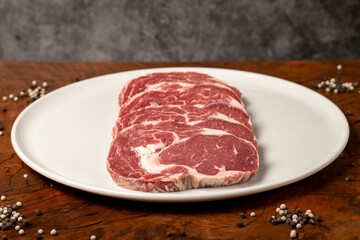 Raw beef ribeye meat. Butcher products. Fresh beef ribeye meat on dark background