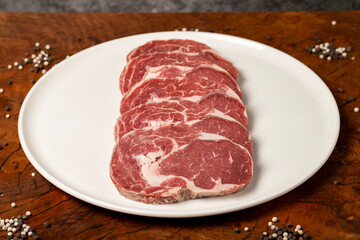 Raw beef ribeye meat. Butcher products. Fresh beef ribeye meat on dark background. Close up
