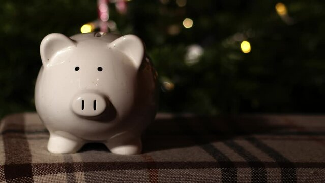 Piggy bank savings in Christmas tree background