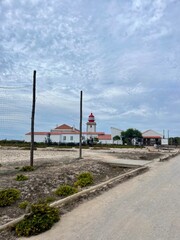 Fototapeta na wymiar Pathway to the Lighthouse, white and red lighthouse, ocean coast