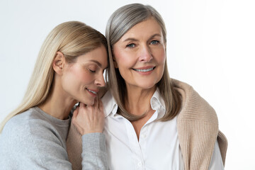 Two women standing close and looking peaceful and relaxed