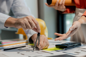 Architects and staff are helping to survey the area in various locations from a blueprint using a compass in order to accurately calculate the width and length before building a house. - obrazy, fototapety, plakaty