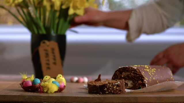 Celebrating Easter chocolate cake s and daffodil flowers display