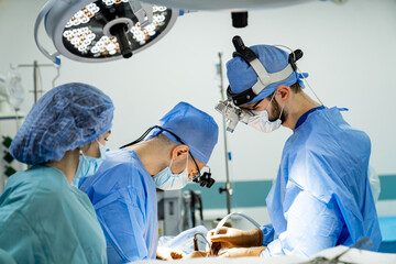 Professional team performing operation. Medical specialists working in team.