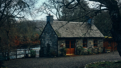 old stone cottage in the woods by river
