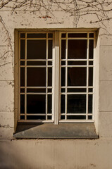 Berlin, Germany, March 7, 2024: close up of a window with intricate subdivisions in a plaster facade