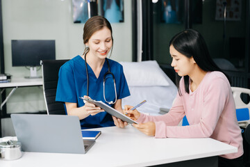 Female doctor using clipboard is delivering great news talk discuss results or symptoms with female patient in clinic or hospital