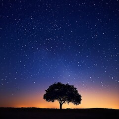 Fototapeta na wymiar A star-filled sky stretches overhead, illuminating the silhouette of a lone tree on a moonlit night