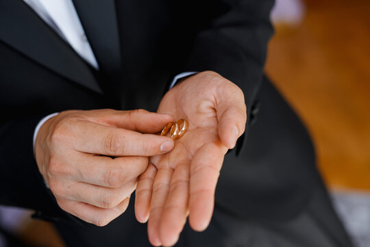 rings on hands of groom