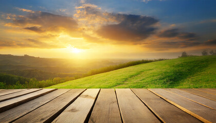 Fototapeta na wymiar Wooden Planks and Sunset Over Grass Field Landscape Background