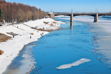 Spring, ice drift on the river, people and birds