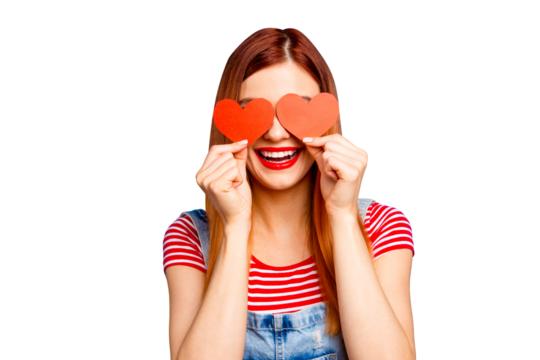 I love you! Close up studio photo portrait of cute lovely pretty with beaming toothy smile girl covering eyes with small little postcards in shape on heart isolated bright vivid background