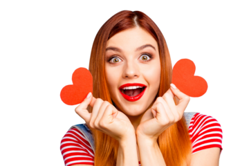 Charming and pretty young girl having two small paper heart in hands, isolated on colourful vivid blue background