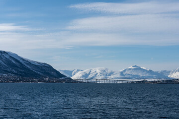Tromsø Bridge and Arctic Cathedral with winter mountain landscape, Tromso, Norway