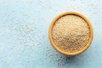Quinoa in a bowl, healthy organic wood, uncooked, shot from the top with a place for text - 761332604