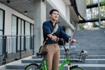Fototapeta na wymiar Young businessman ride bicycle to work. Reduce global warming Help save energy. Eco friendly concept