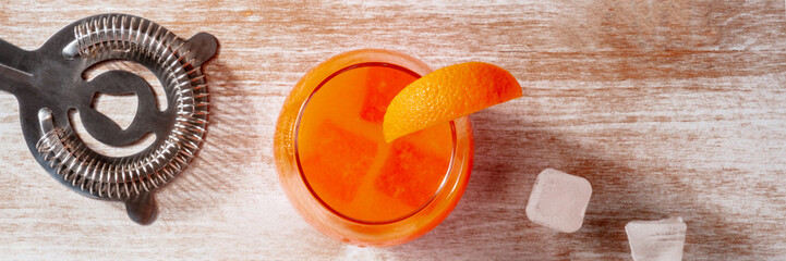 Orange drink with ice, panorama, overhead flat lay shot on a wooden background - 761334266
