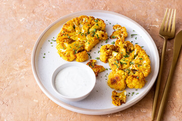 Cauliflower steaks with white sauce. Healthy eating. Vegetarian food.