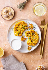 Cauliflower steaks with white sauce. Healthy eating. Vegetarian food.