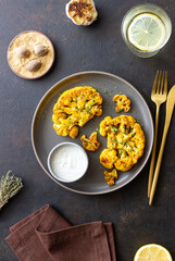 Cauliflower steaks with white sauce. Healthy eating. Vegetarian food.
