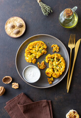 Cauliflower steaks with white sauce. Healthy eating. Vegetarian food.