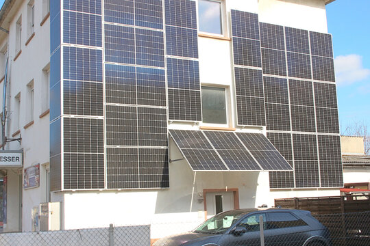 Image of a building with electric solar panels, green energy, on a sunny day.