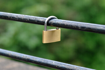Single Padlock Hanging on Steel Bar of Old Bridge