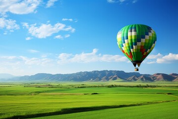 Fototapeta premium Aerial view of hot air balloon flying above verdant fields with ample copy space