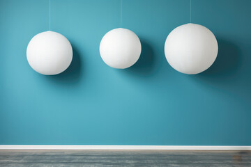 Three white globes hanging from ceiling in blue room