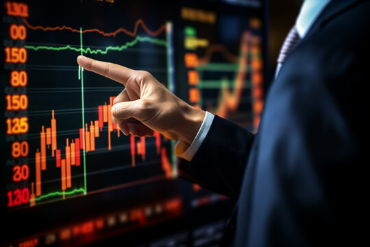 Hand of businessman point to the screen show financial market chart graphic.