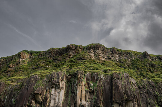 amazing great cliff standing on the coastline, like a big stunning castle, cloudy day, in Keelung, Taiwan.