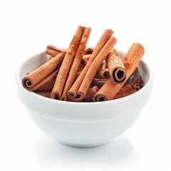A collection of cinnamon sticks rest in a ceramic bowl on a white background. The cinnamon sticks are a warm brown color and some are rolled together.