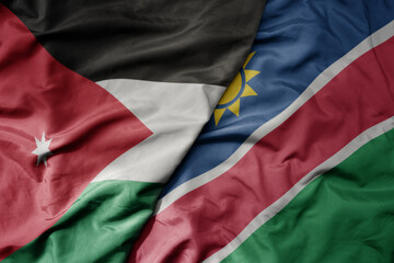 big waving national colorful flag of namibia and national flag of jordan.