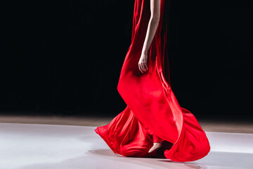 Beautiful elegant details of a bright red long silky dress. Women's fashion