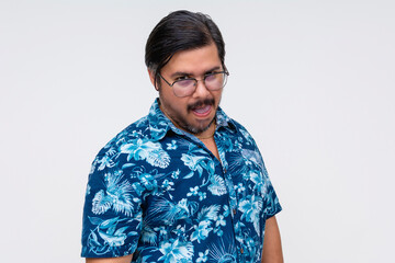 A playful if not creepy weird man in a blue Hawaiian shirt sticking out his tongue, evoking fun and silliness. Isolated on white.