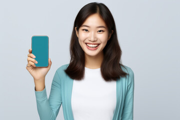 Fototapeta premium Woman is holding cell phone with blue background