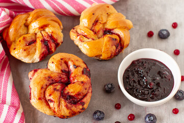 Homemade twisted rolls with blueberries sauce