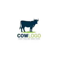 Green cow silhouette on grass with tagline