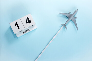 June calendar with number  14. Top view of a calendar with a flying passenger plane. Scheduler....